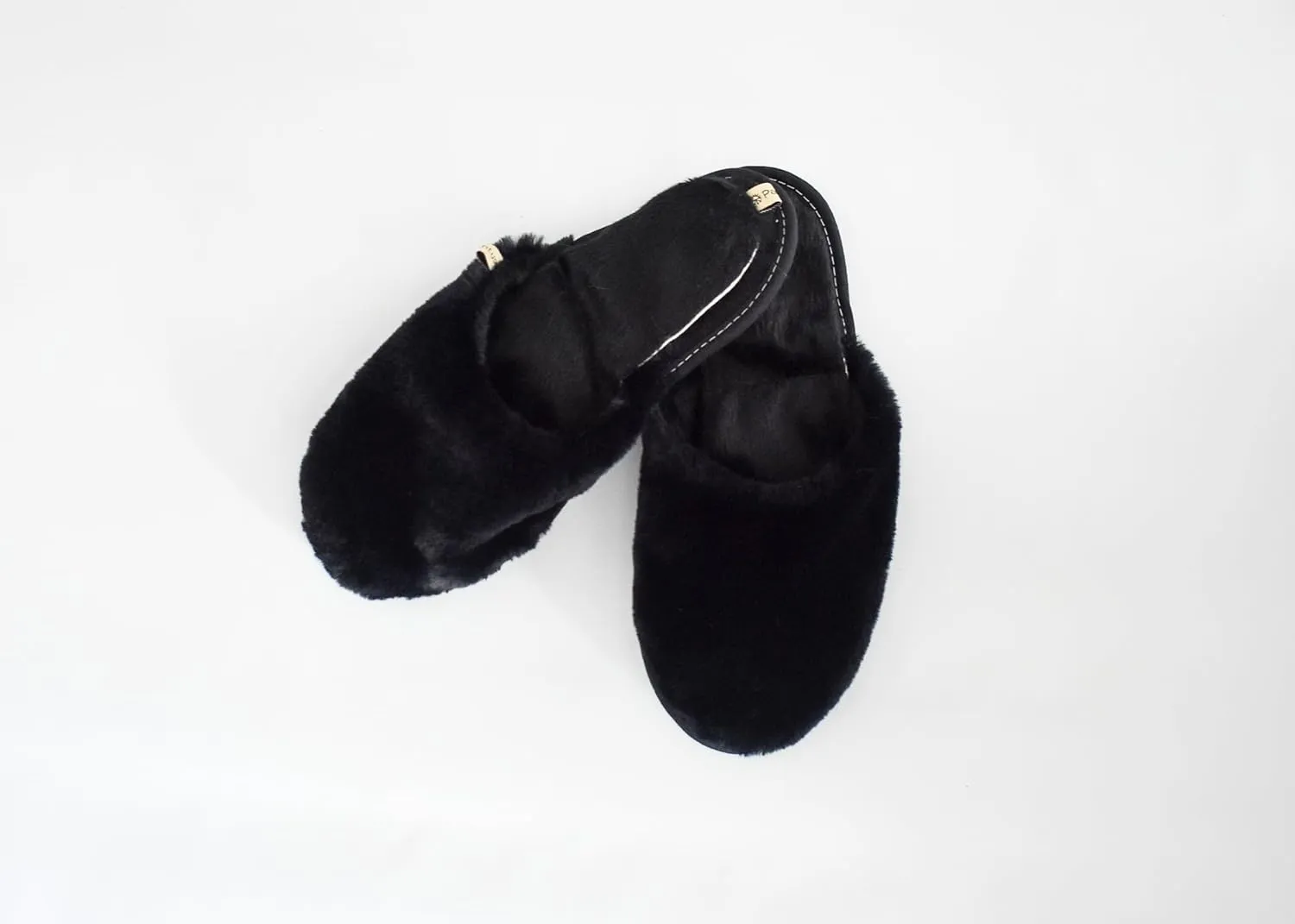 slide on Aromatherapy women's slippers featuring heatable lavender-filled aromatherapy insoles. Spa-style slide-on slippers with a fuzzy faux fur exterior.