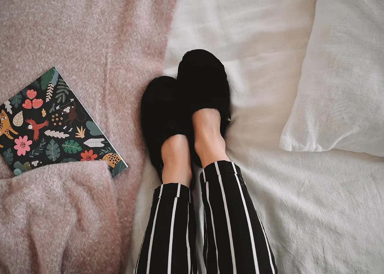 slide on Aromatherapy women's slippers featuring heatable lavender-filled aromatherapy insoles. Spa-style slide-on slippers with a fuzzy faux fur exterior.